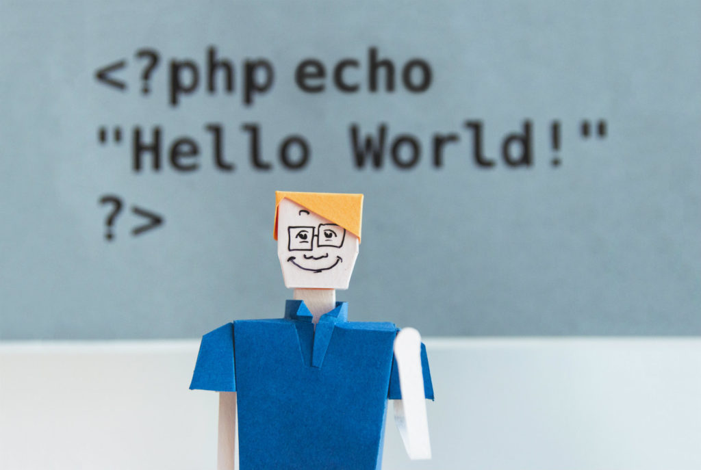 A paper figure of a man against the background of the PHP code