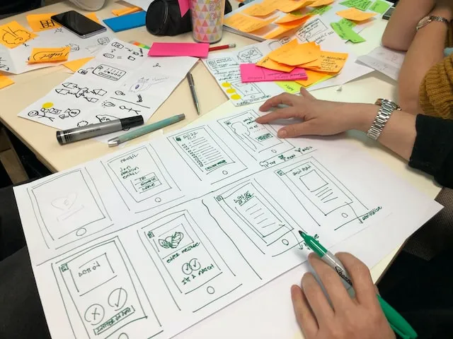 A some kind of workshop where people draw various concept ideas